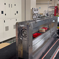 Close-up side view of a metallic machine assembly structure during an oil seal and gasket inspection.